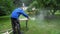 Handyman with protective mask and glasses polishing wood boards with grinder