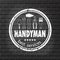 Handyman services design for your logo or emblem with stamp on the gray brick wall. Set of workers tools.