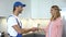 Handyman shaking hand with satisfied female client, professional repair services