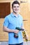 Handyman Standing Outside Garden Shed With Tools