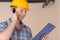 Handyman talking at phone.