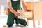 Handyman in uniform assembling furniture indoors, closeup