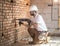 Handyman uses jackhammer, for installation, professional worker on the construction site. The concept of electrician and handyman