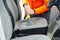 Handyman vacuuming car front textile seat with vacuum cleaner. man cleaning work machine