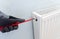 Handyman venting a radiator or heater to let the air escape