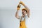 Handyman in yellow uniform changing light bulb. House renovation conception