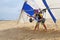 Hang glide student prepares for takeoff on sand dunes in North C