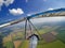 Hang glider pilot fly high over endless green fields