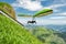 Hang glider pilots flies from steep slope