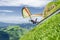 Hang glider pilots launches from steep slope high in the mountains