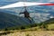 Hang gliding over valley farmlands and mountains