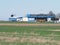 Hangar of local sport airport and black helicopter, grassy field landscape in european Bielsko-Biala city at Poland