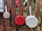 Hanged enamel saucepans on a wooden fence