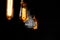 Hanged orange decoration light bulbs in dark room with non-col