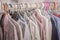 Hangers with children`s clothes hanging on a stand in a closet