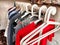 Hangers with a variety of clothes on a white rack. Home storage of clothes. Clutter. Littery. Declutter. Garage sale