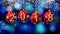 Hanging 2018 number glitter Christmas balls on blue bokeh background.