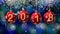 Hanging 2018 number glitter Christmas balls on blue bokeh background. 4K