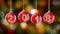 Hanging 2018 number glitter Christmas balls on gold bokeh background.
