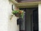 Hanging baskets of flowers on a cottage Ireland