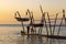 Hanging boats of Savudrija Boats hanging from traditional wooden cranes at sunset