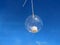 Hanging candle in the glass bowl for tropical beach and blue sky