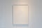 Hanging empty wooden picture frame on orderly dot or hole wall with orange light form ceiling