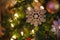 Hanging Festive Silver Glittering Snowflake bauble background with decorated green Christmas Tree in shopping mall. Special