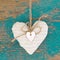 Hanging heart and turquoise wooden background in country style.