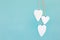 Hanging hearts and turquoise background in country style. Chic, card.