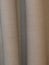 Hanging horizontally ribbed beige curtains