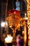 Hanging icon lamp of transparent red glass in golden holder in Orthodox church. Gilded church altar utensil. Closeup