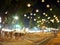 Hanging lanterns over walking zone with unidentified crowed moving around in large THAI national street fair LOY KRATHONG