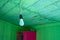 Hanging modern light bulb with green wooden planks