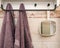 Hanging objects in the bathroom: two towels and a white mirror