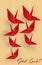 Hanging origami paper cranes in red color with Good Luck! text on brown background