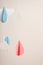 Hanging paper garland on beige background for children`s and adult holiday - birthday, new year, newborn. Pastel colors