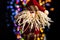 Hanging Santa Claus Christmas decoration against bokeh lights background