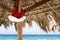 Hanging Santa Claus hat on palmy sunshade