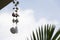 Hanging seashell wind chime mobile against sky background