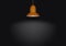 Hanging shining orange lamp on black background