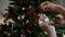 Hanging shiny transparent and white holiday bauble on decorated christmas tree