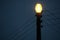 A hanging street lamp against a serene dark sky