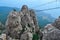 Hanging suspension bridge over an abyss in steep rocks Ai-Petri, Crimea. Against the backdrop of the Black Sea