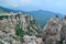 Hanging suspension bridge over an abyss in steep rocks Ai-Petri, Crimea. Cliff against the backdrop of blue mountains