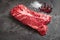 Hanging Tender steak on a stone background with salt and pepper - onglet steak