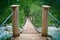 Hanging wooden bridge over mountain river