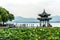 HANGZHOU, CHINA JUNE 08, 2018 : The beautiful landscape scenery of Xihu West Lake and pavilion with boat and mountain in Hangzhou