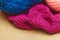 Hanks of bright yarn for knitting on a bright background