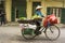 Hanoi, Vietnam - April 13, 2014: Unidentified food vendor sells fruits carried by bike on Hanoi street, Vietnam. The old looked ho
